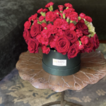 Mel | red florals set against green hydrangeas